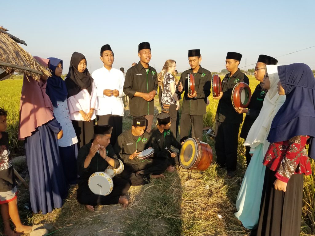 Both the Chamber Choir and an Indonesian choir sang in a rice field. Trip participants stop to listen to Indonesian music.